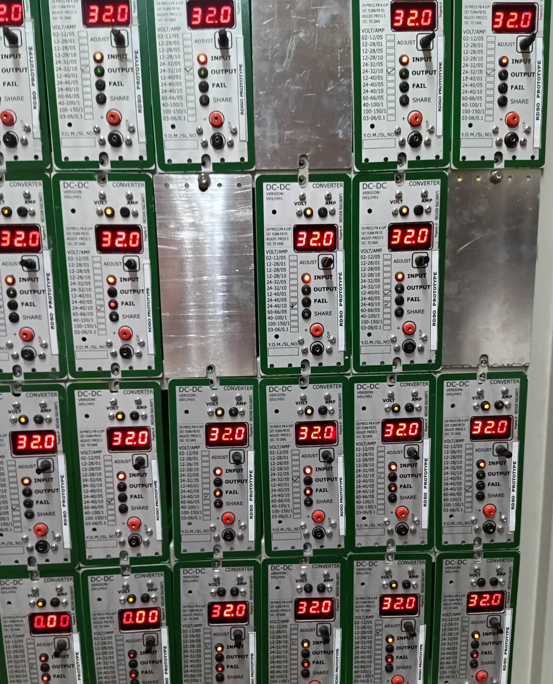 Close view of DC-DC converter modules with red seven-segment readouts and status LEDs