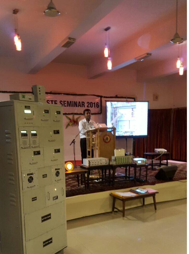 An IPS rack standing on stage at the STE Seminar 2016, with a presenter at the lectern
